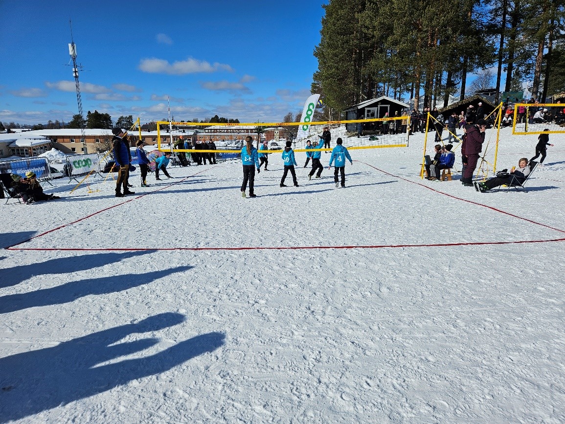 Parents watching Mixed Kids snow volleyball matches