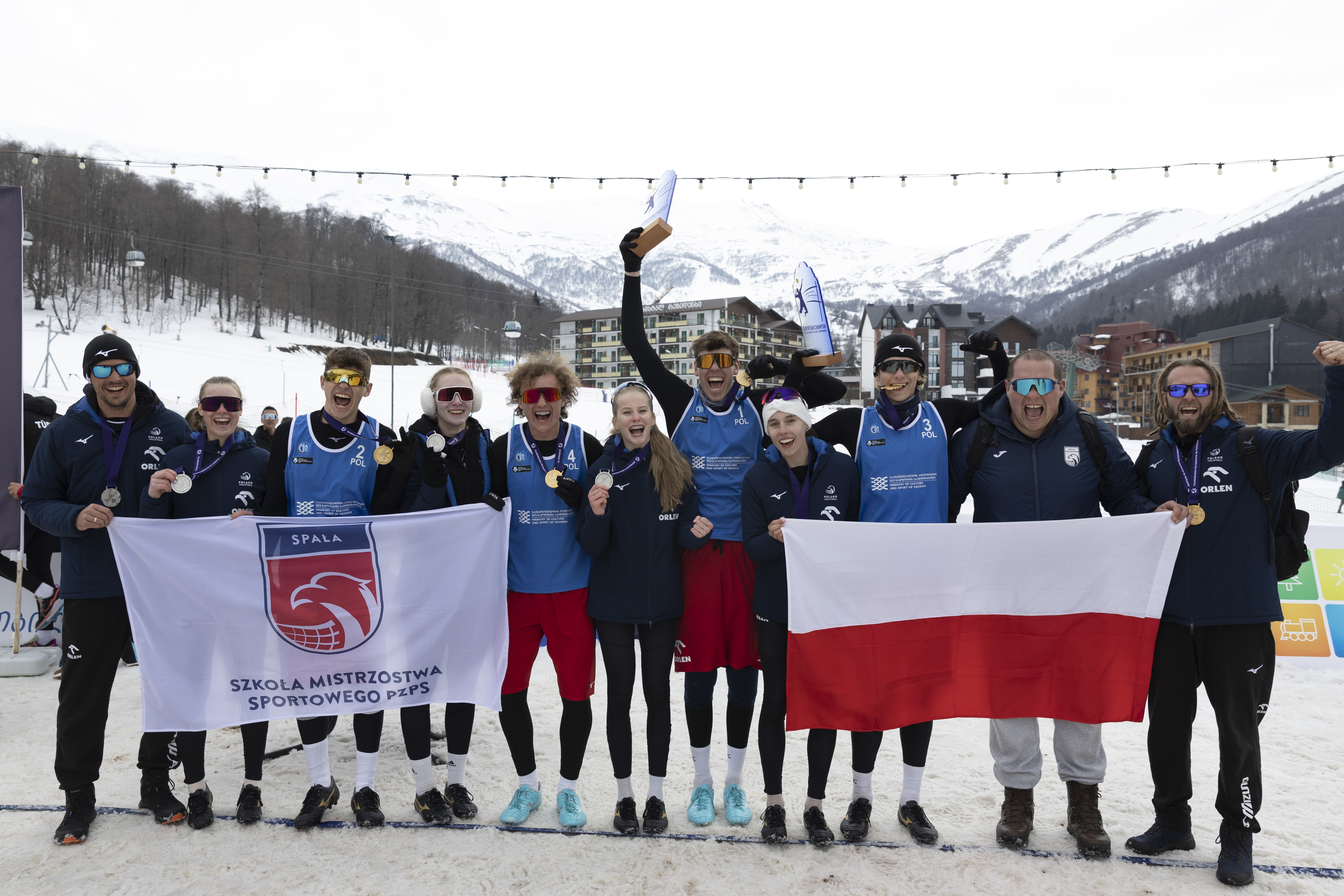 Snow Volleyball players celebrating a point in snowy mountains