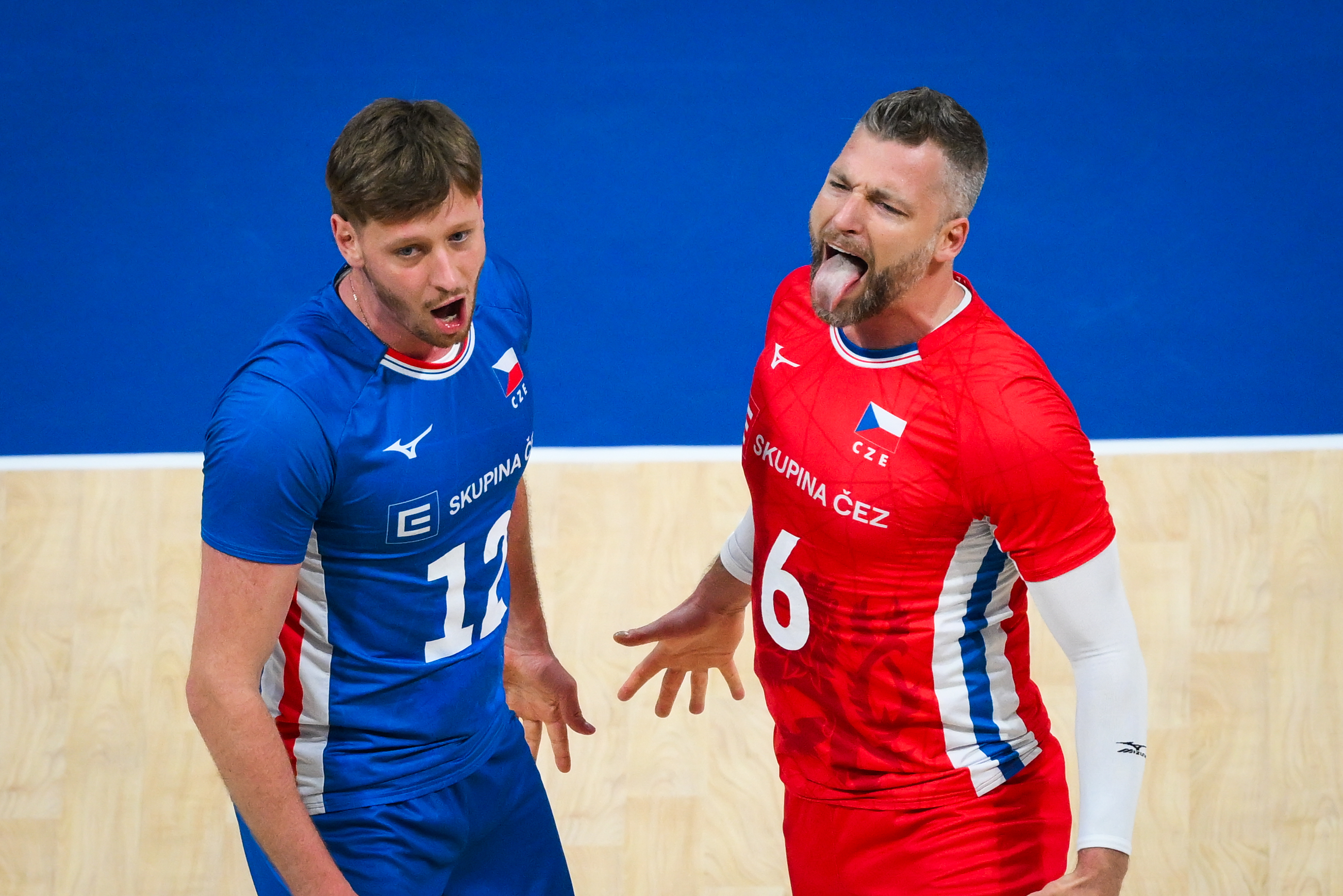 Volleyball player spiking the ball over the net
