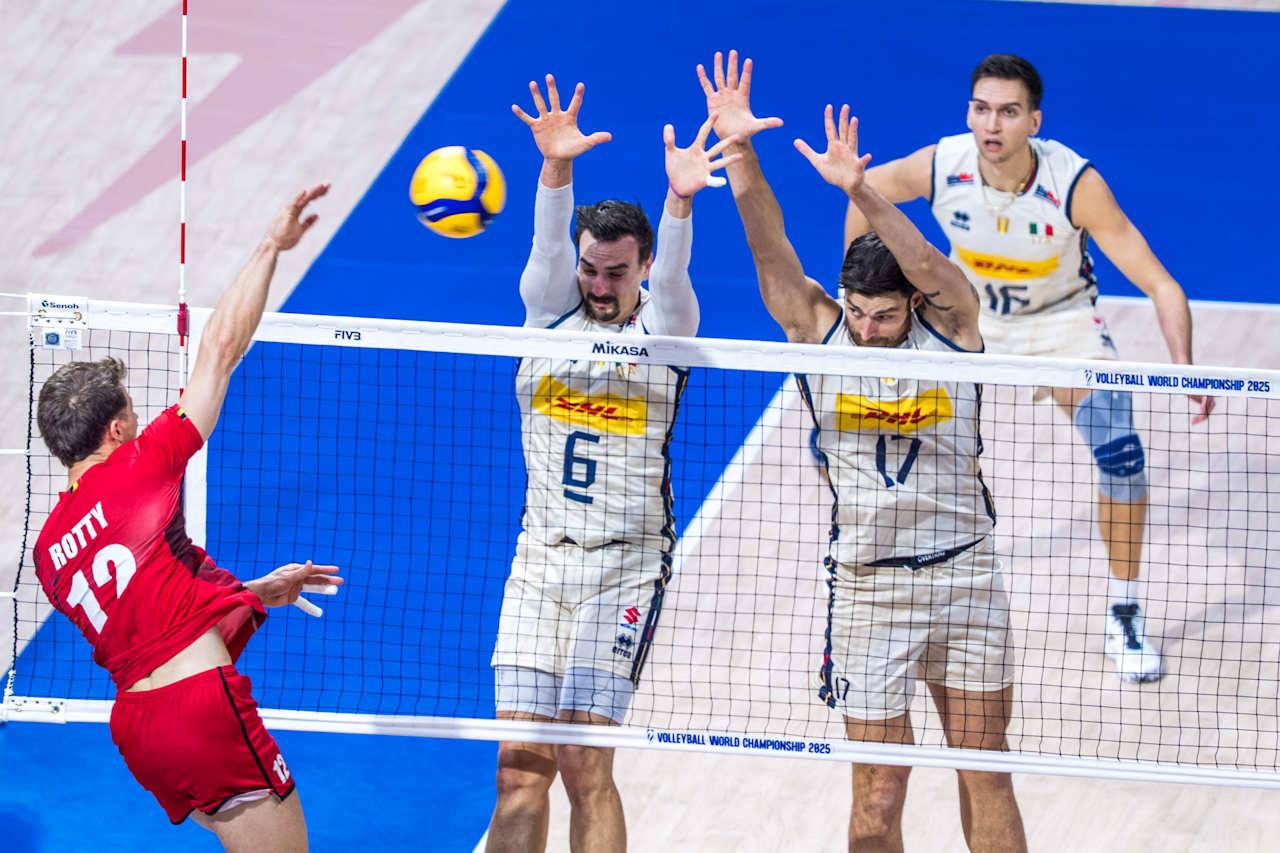 Volleyball team huddle on court during a break