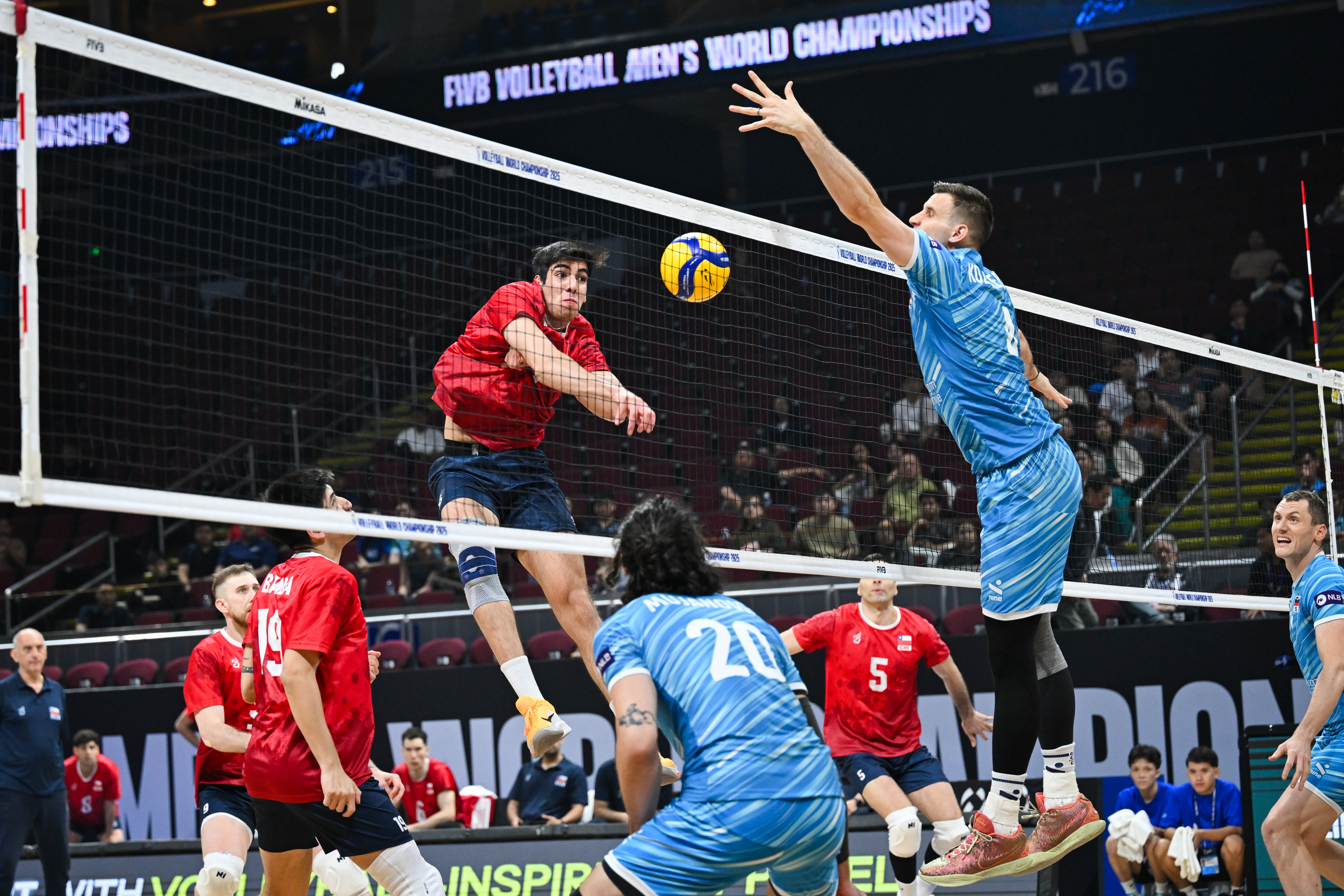USA volleyball player serving during a match.