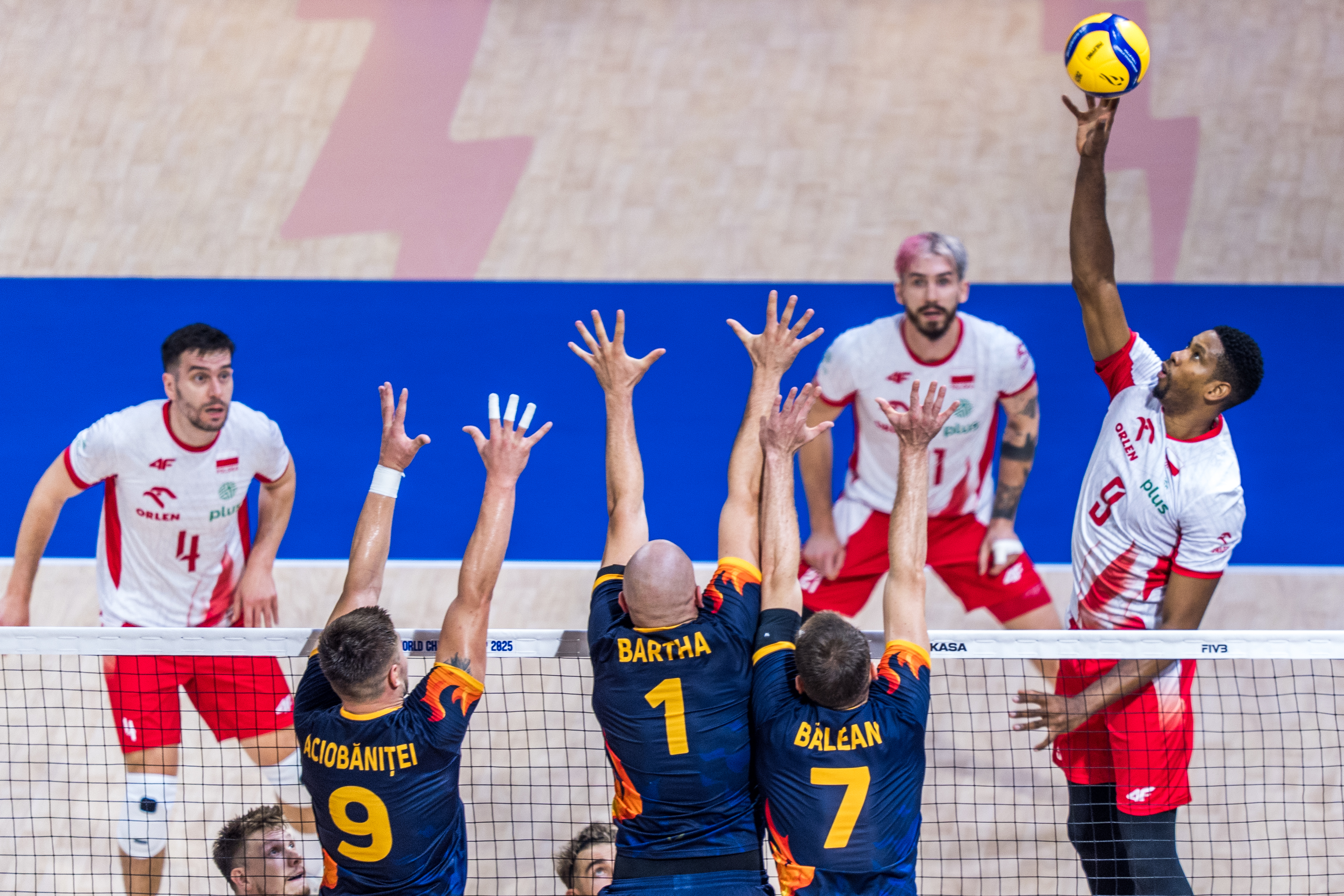 Volleyball players in action on the court.