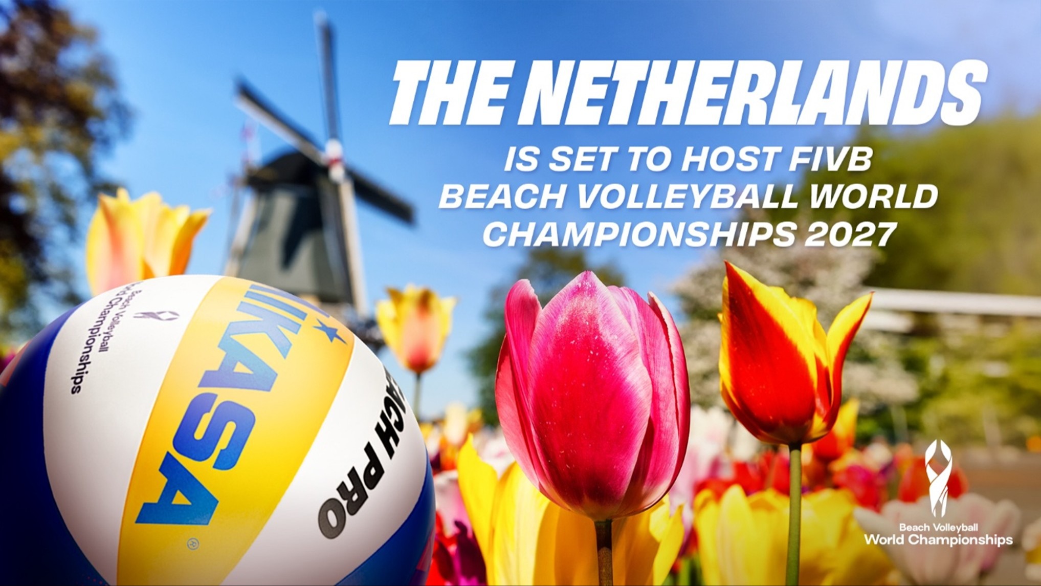 Beach Volleyball players celebrating in the Netherlands, with a stadium in the background.