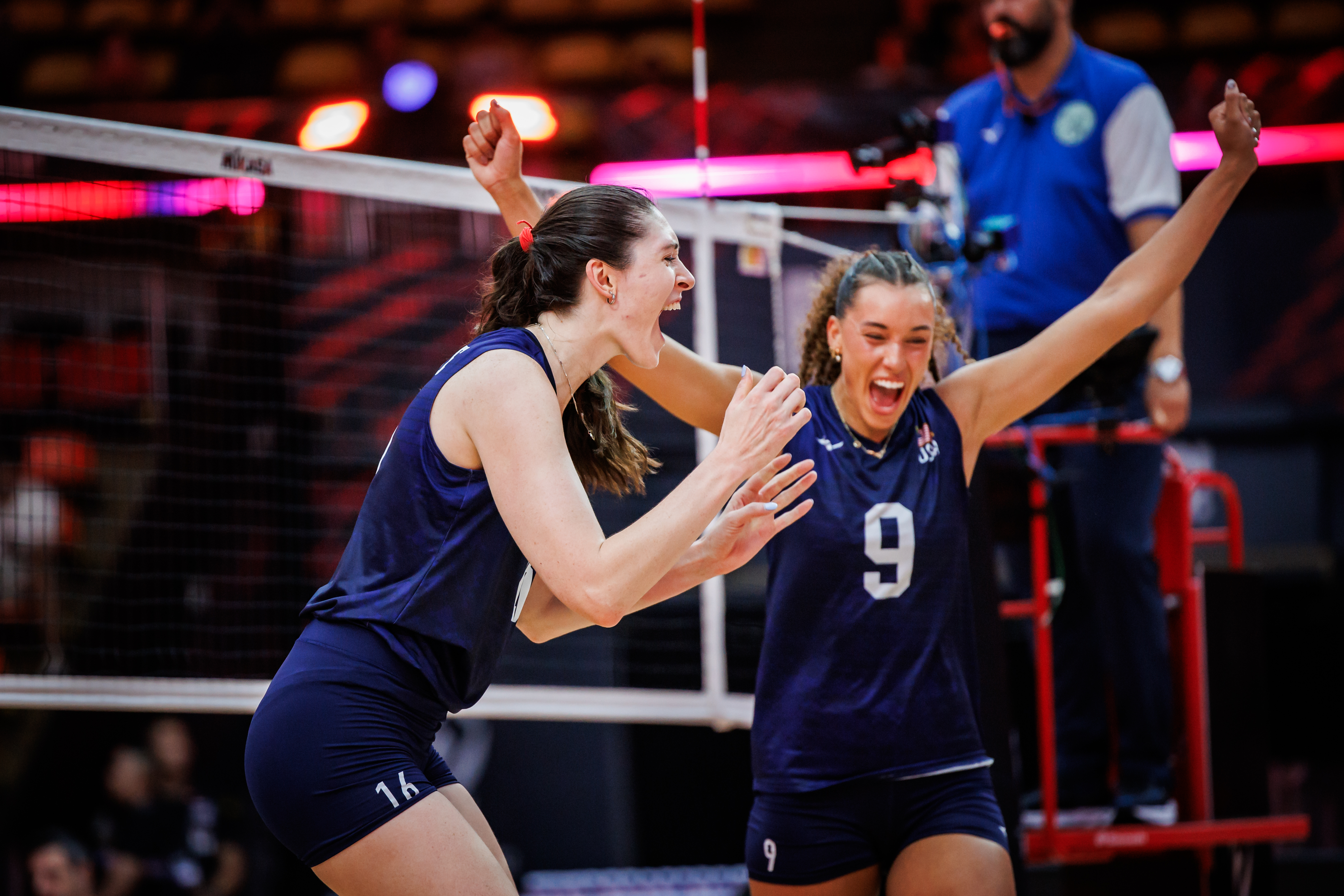 USA and Canada volleyball teams on the court during a match.