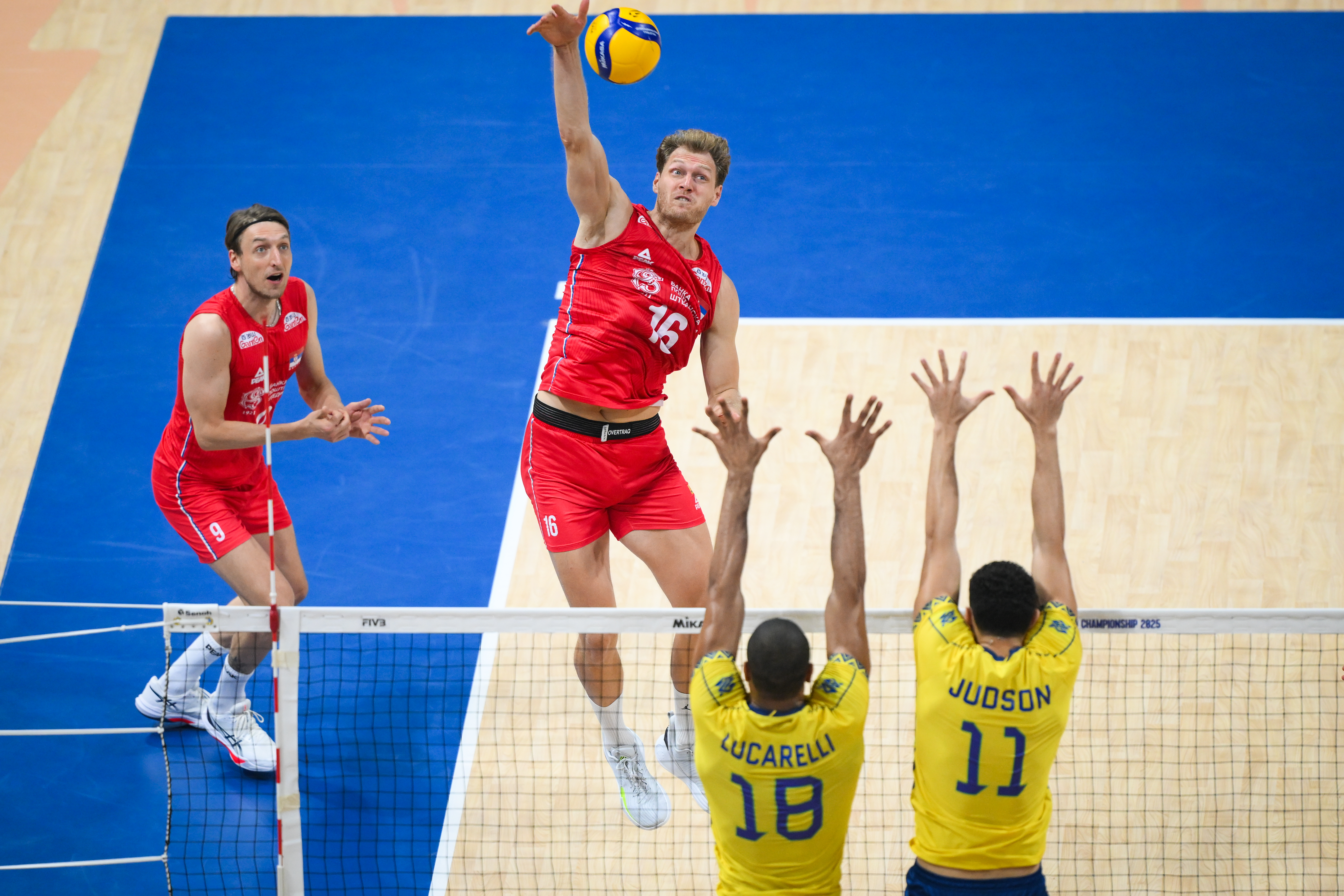 Volleyball player blocking at the net
