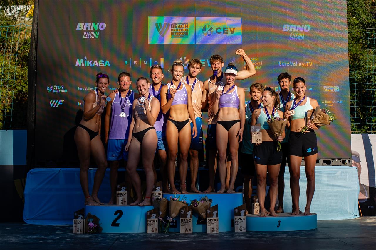 Podium ceremony with winning teams at the Brno Beach Pro Tour Futures event, showing happy Czech athletes.