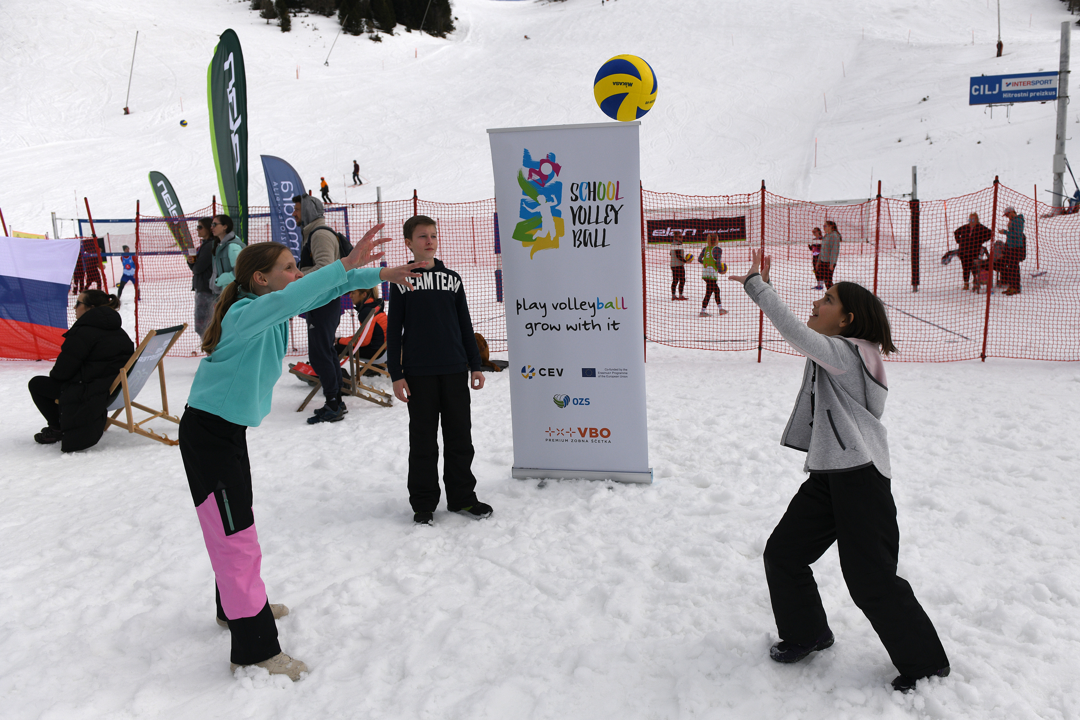 Kids interacting with Snow Volleyball players