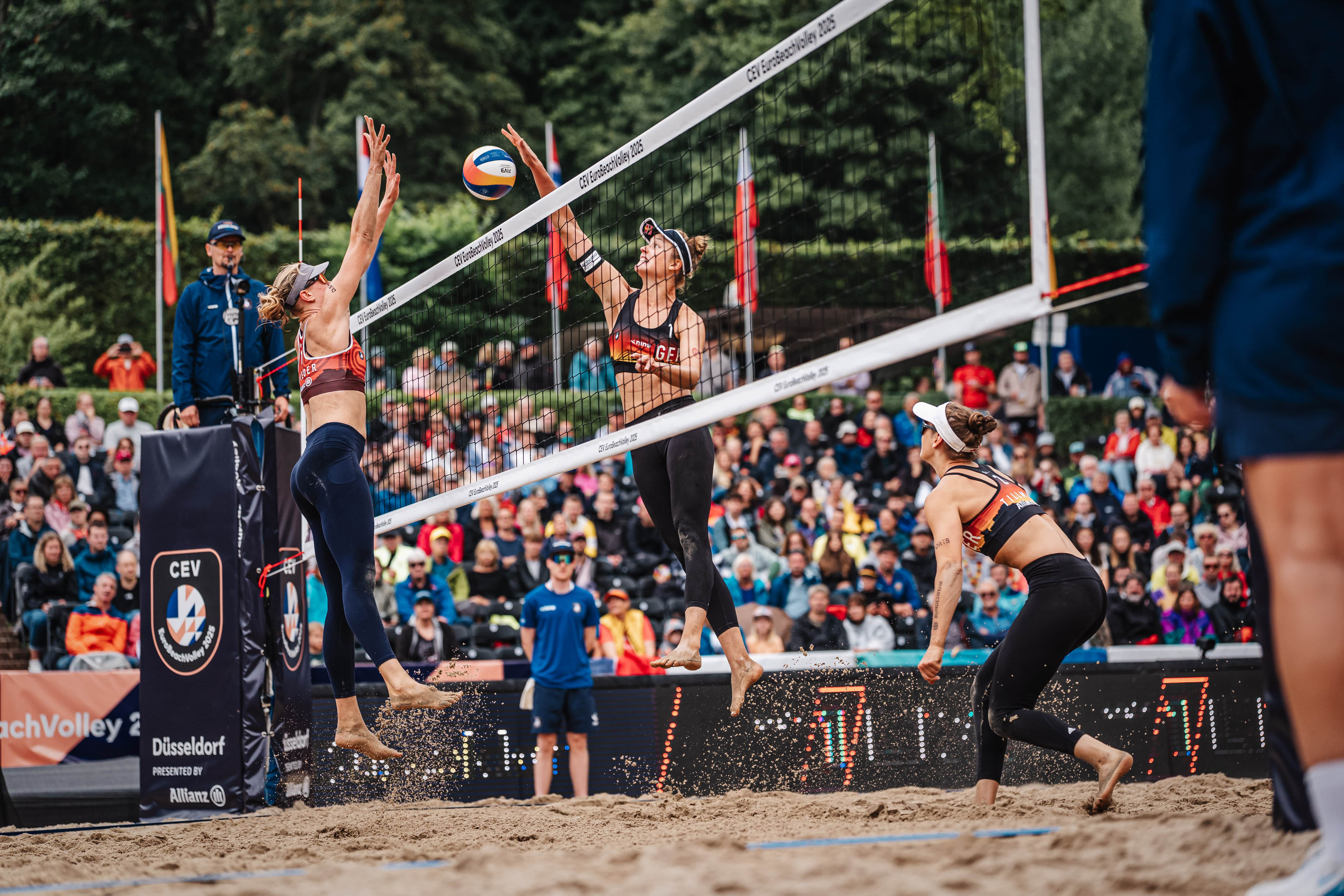 German beach volleyball player Svenja Müller mid-action during a match.