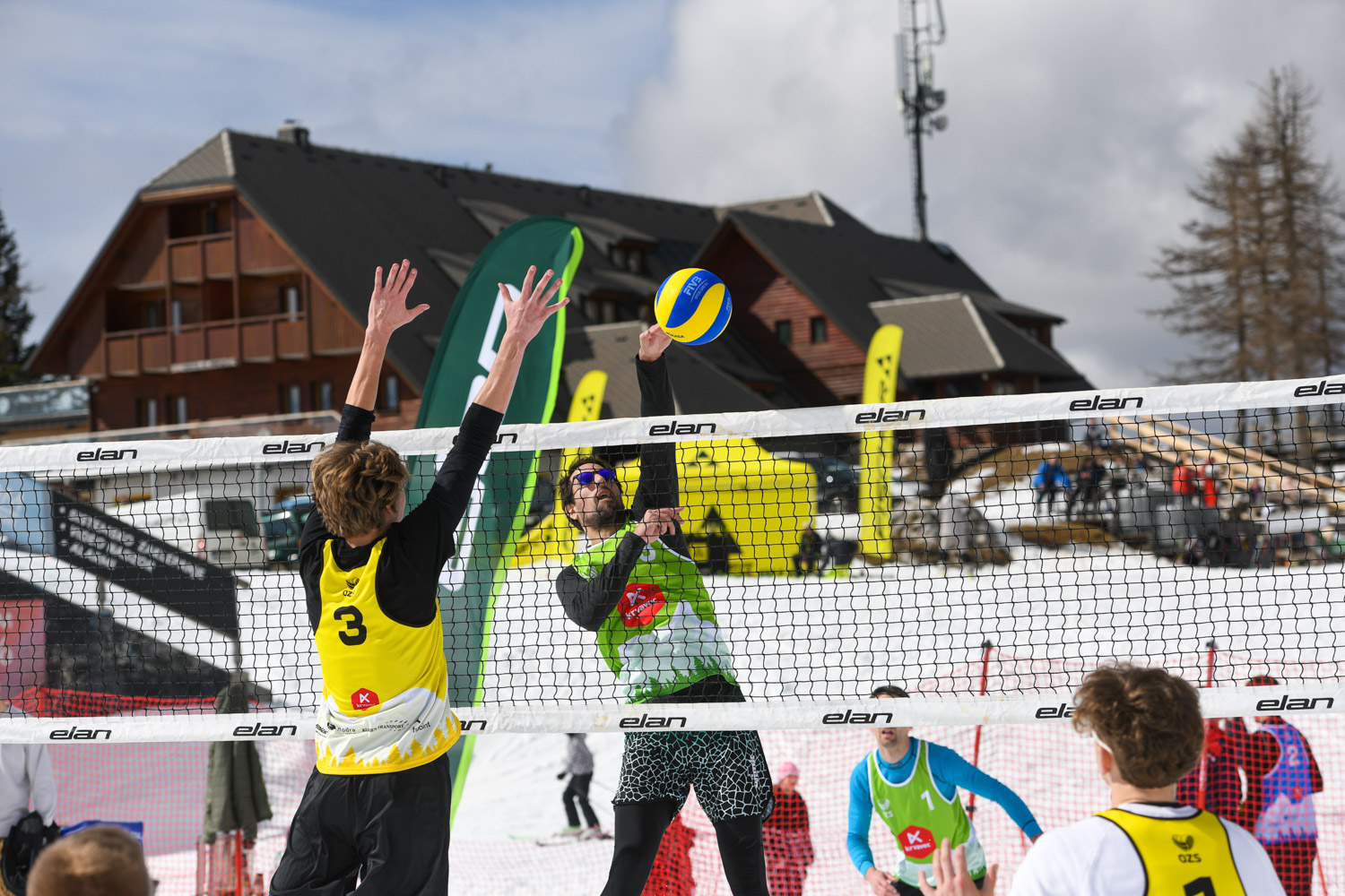 View of several snow volleyball courts with players during the 2024 Slovenian championships.