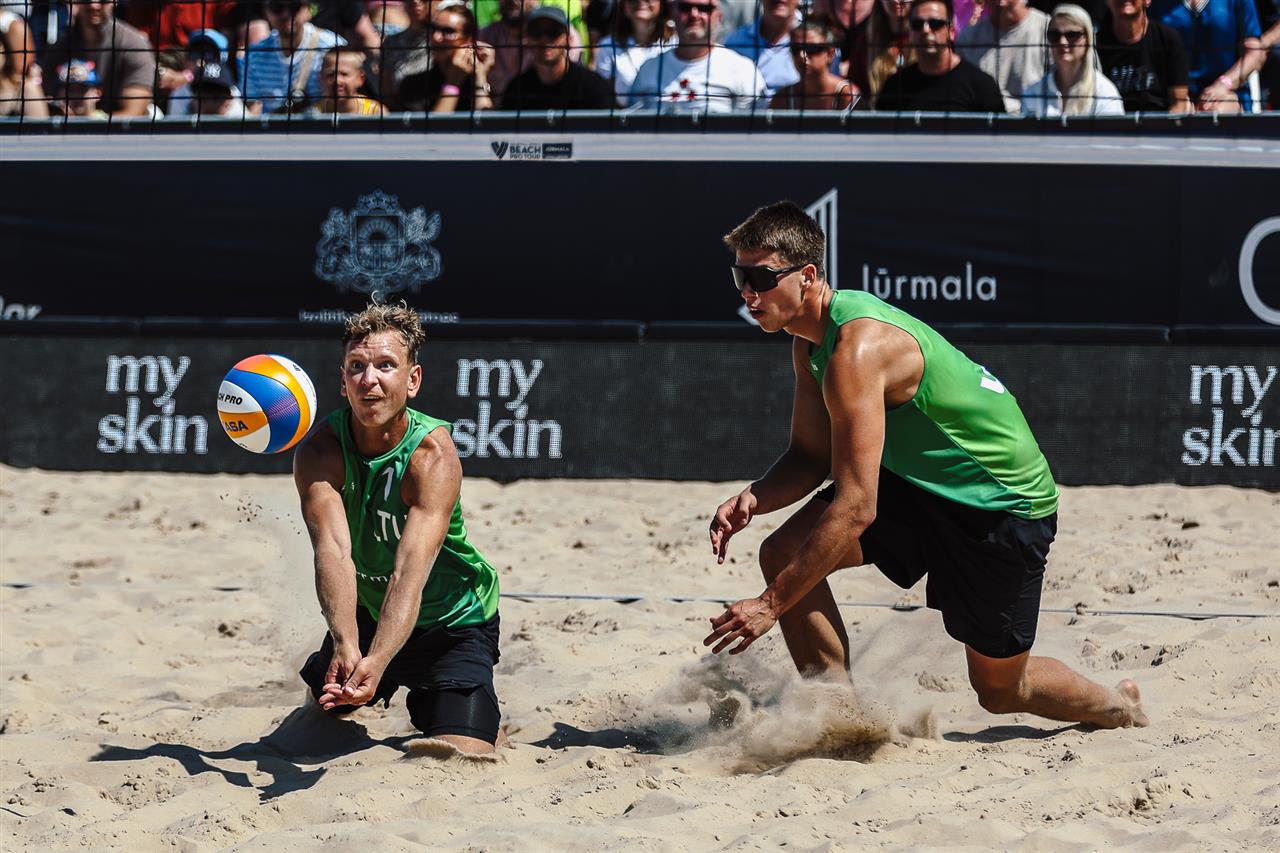 Arnas Rumsevicius and Karolis Palubinskas playing beach volleyball