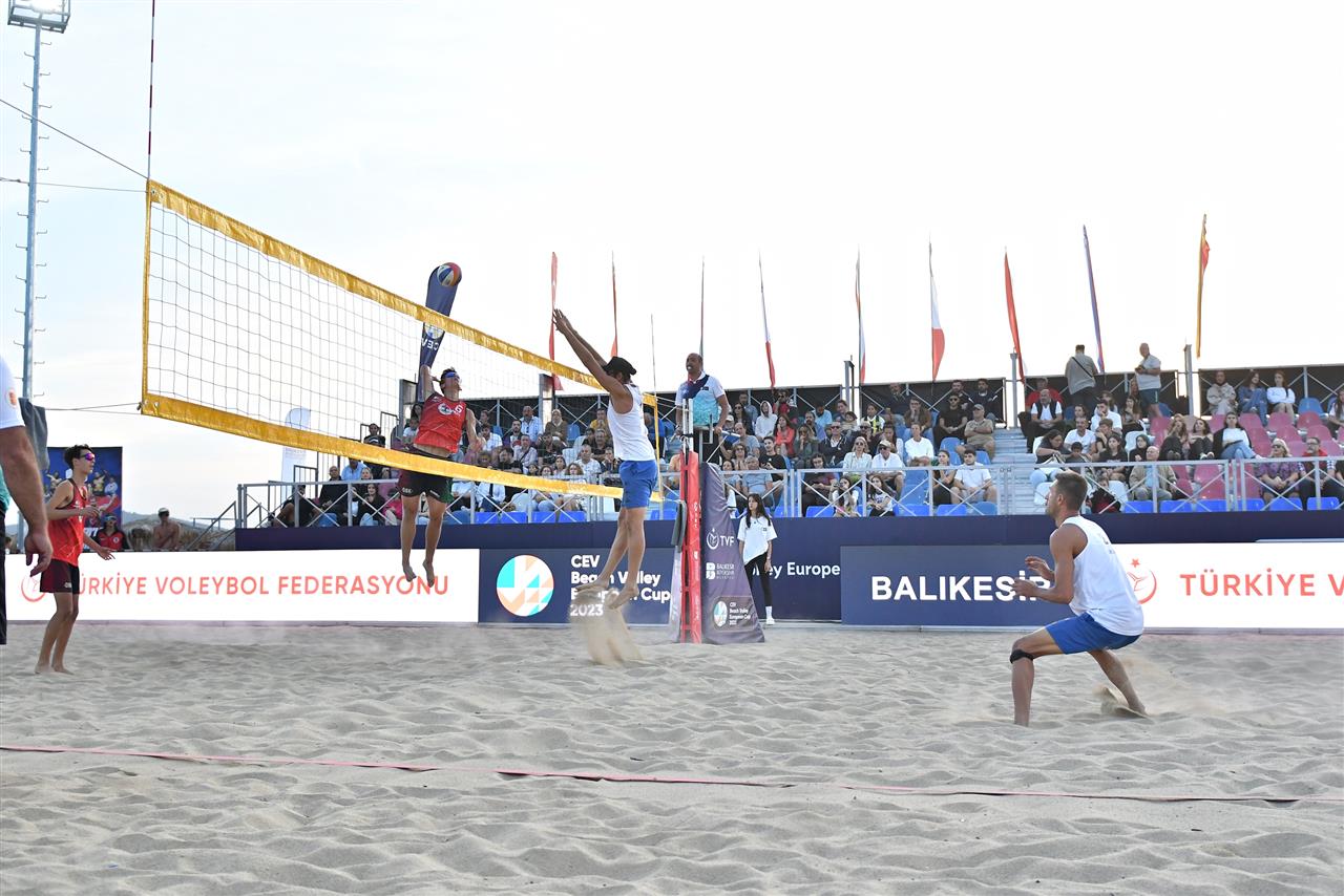 Beach volleyball action at the CEV Beach Volley European Cup, showcasing a dynamic match on the sand.