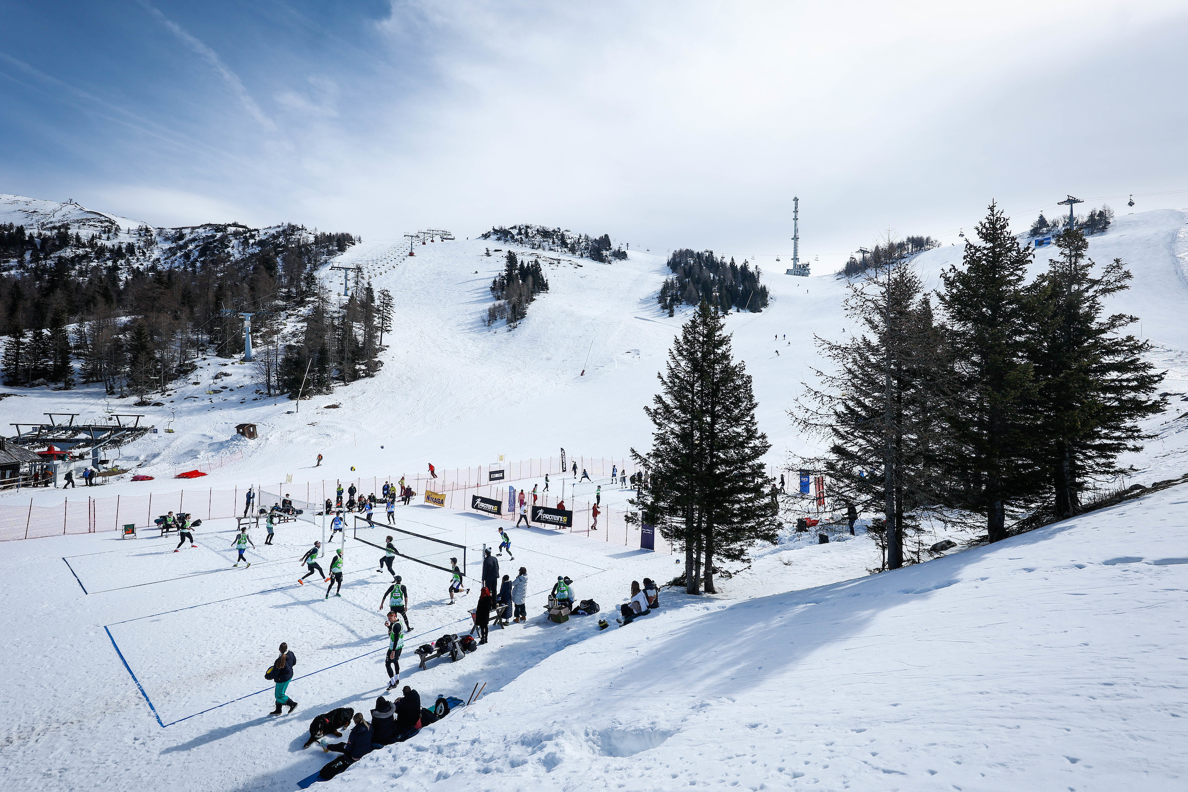 Snow volleyball action at Krvavec ski resort with players in action.