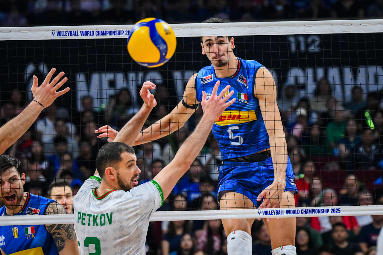 Volleyball players in action during a match, a dynamic team play.